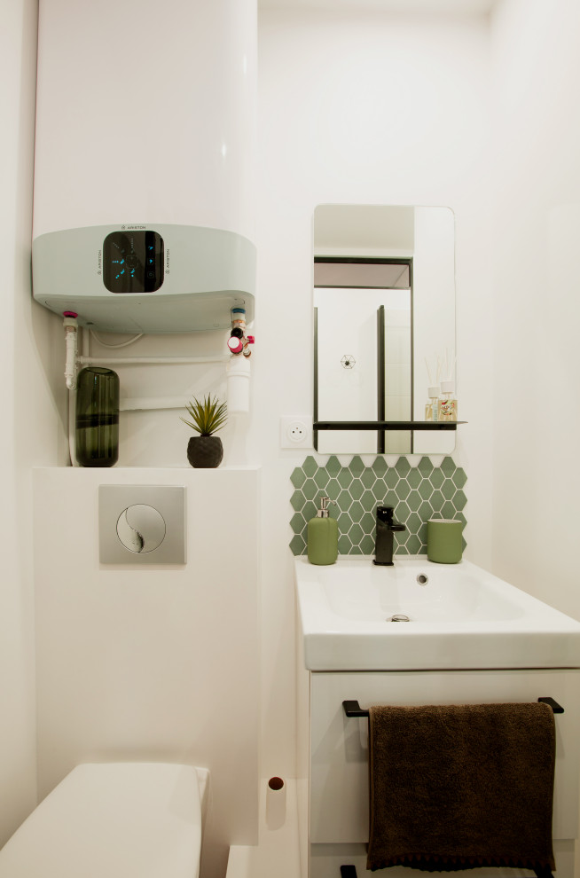 Small industrial 3/4 bathroom in Paris with beaded inset cabinets, white cabinets, an alcove shower, a wall-mount toilet, green tile, mosaic tile, white walls, light hardwood floors, an undermount sink, beige floor, a hinged shower door, white benchtops, a single vanity and a floating vanity.