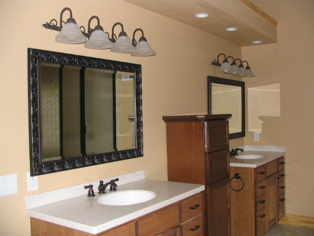 Drop-in bathtub - large rustic master brown tile and ceramic tile ceramic tile drop-in bathtub idea with raised-panel cabinets, medium tone wood cabinets, a two-piece toilet, brown walls, an integrated sink and solid surface countertops
