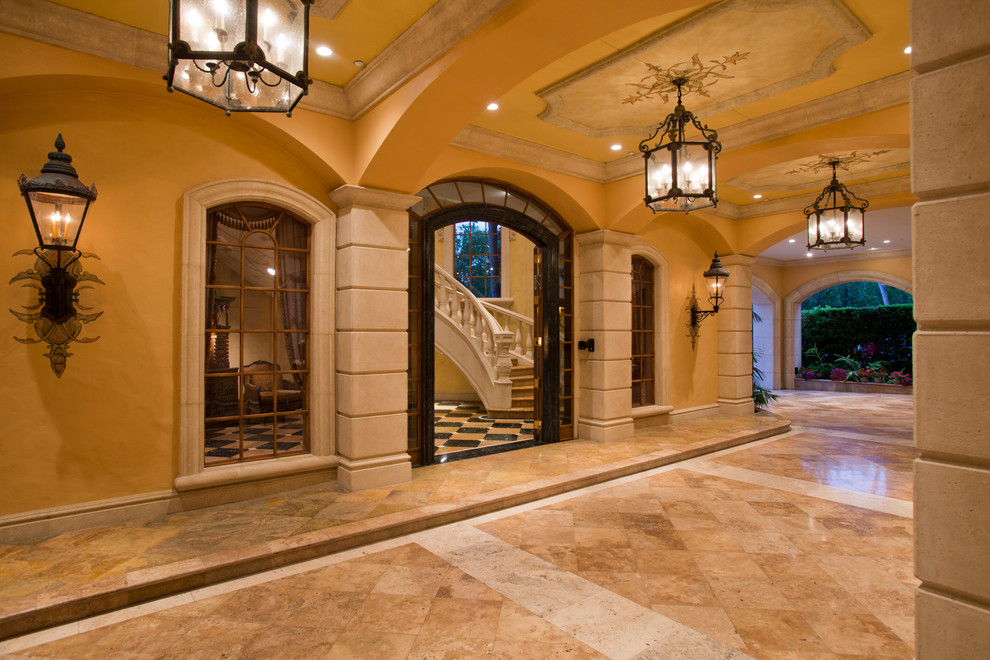 Expansive mediterranean hallway in New York with yellow walls and marble floors.