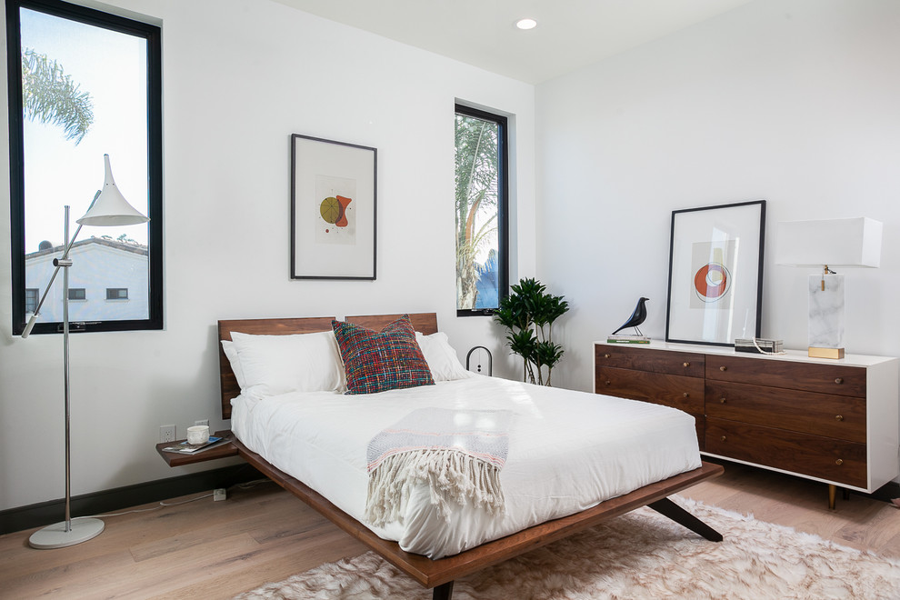 Contemporary master bedroom in Orange County with white walls, light hardwood floors and beige floor.