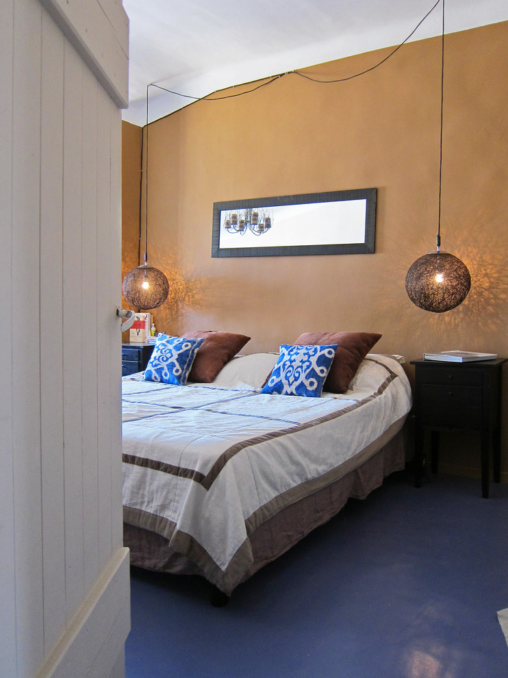 Design ideas for a large mediterranean master bedroom in Marseille with brown walls and linoleum floors.