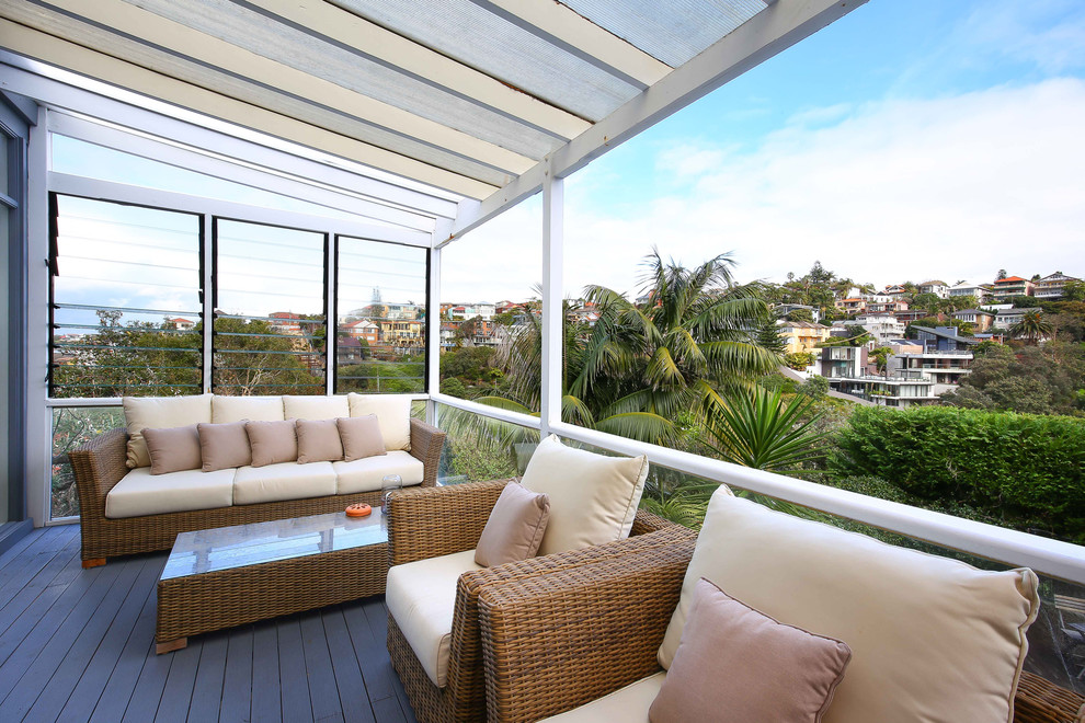 Design ideas for a beach style deck in Sydney with an awning.