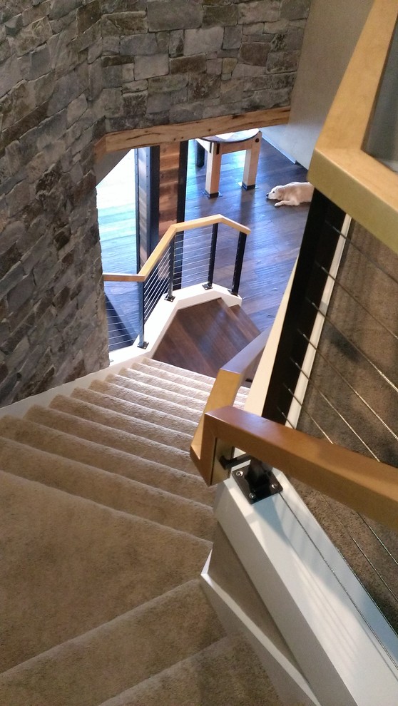 Design ideas for a mid-sized contemporary carpeted curved staircase in Portland with carpet risers.