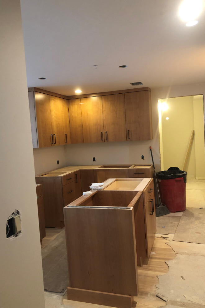 Inspiration for a small kitchen remodel in Denver with brown cabinets and an island