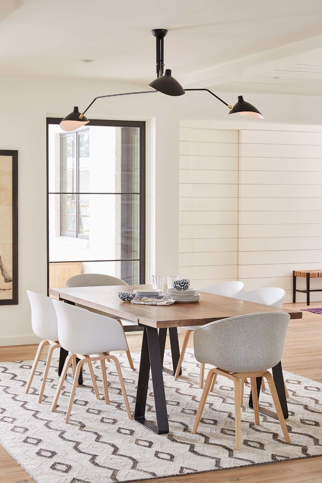 Transitional dining room in Charlotte with white walls and light hardwood floors.