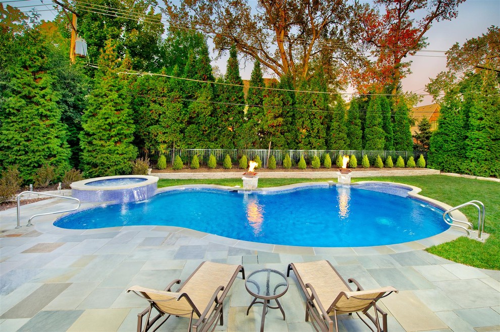 Inspiration for a large traditional backyard custom-shaped lap pool in Chicago with a hot tub and tile.
