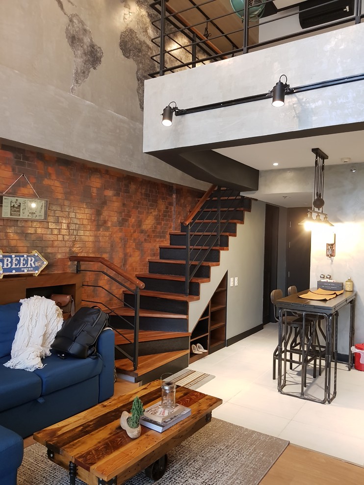 Industrial open concept living room in Other with multi-coloured walls, light hardwood floors and beige floor.