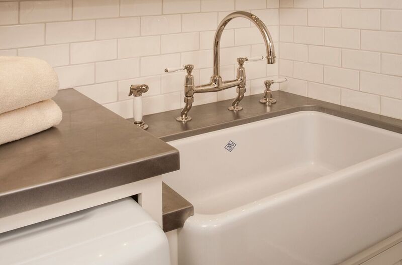 Inspiration for a traditional bathroom in Seattle with white cabinets and concrete floors.