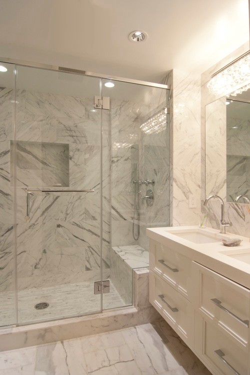 Design ideas for a small modern master bathroom in New York with gray tile, white walls, recessed-panel cabinets, white cabinets, an alcove shower, a one-piece toilet, marble, marble floors, an undermount sink, engineered quartz benchtops, white floor and a hinged shower door.