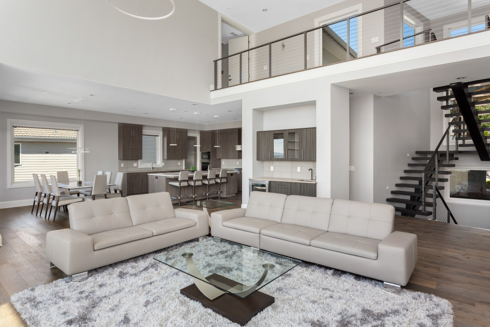 Photo of a large modern formal open plan living room in Tampa with beige walls, light hardwood flooring, no fireplace, no tv, brown floors and a drop ceiling.