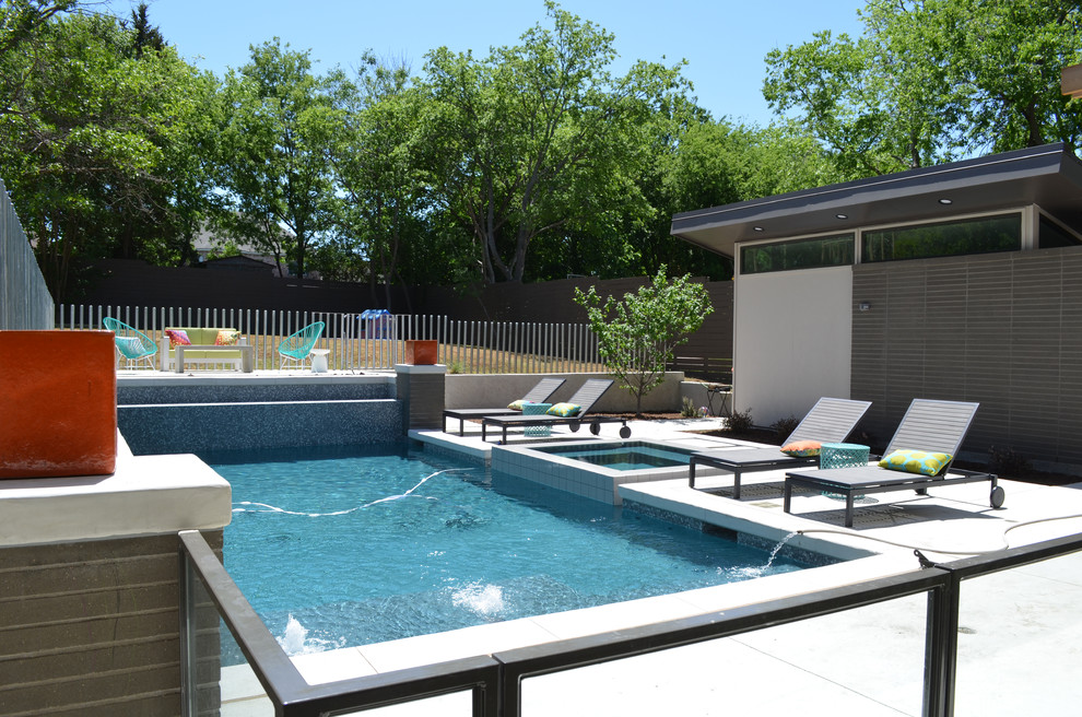 Inspiration for a contemporary backyard rectangular pool in Dallas with concrete slab.