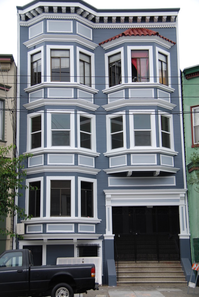 Photo of a traditional three-storey grey exterior in San Francisco with a flat roof.
