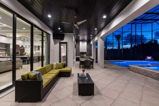 Large backyard tile patio kitchen photo in Orlando with a roof extension
