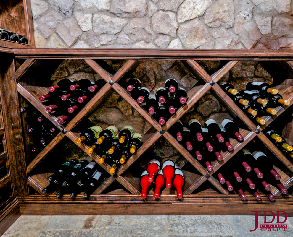 Design ideas for a mid-sized midcentury wine cellar in San Diego with travertine floors and display racks.