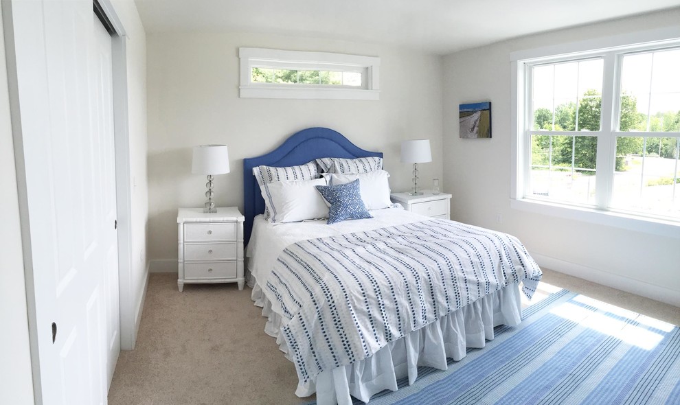 Photo of a mid-sized beach style guest bedroom in Boston with white walls, carpet and no fireplace.