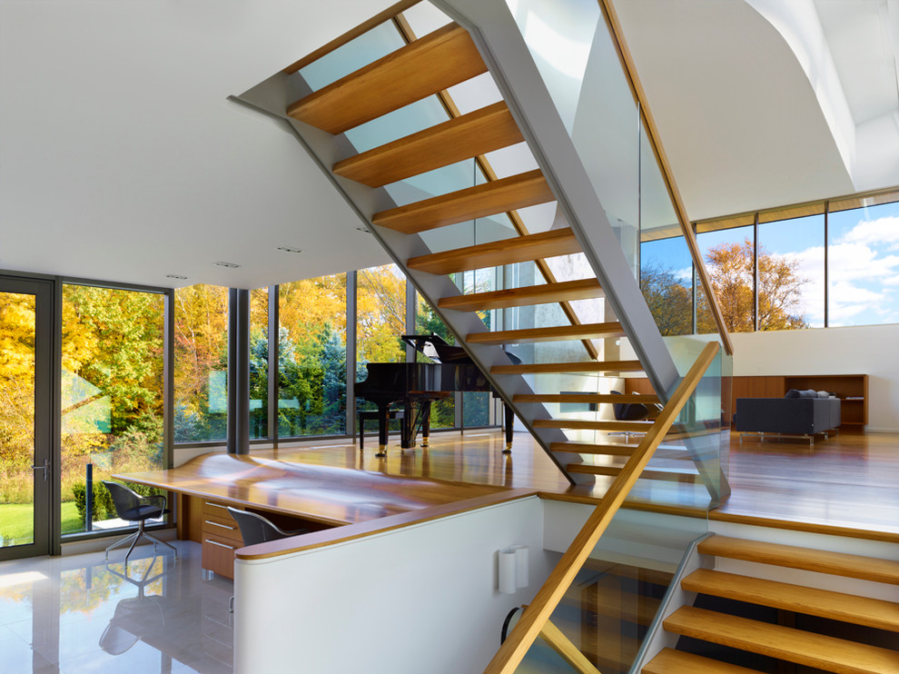 Photo of a contemporary wood floating staircase in Toronto with open risers.