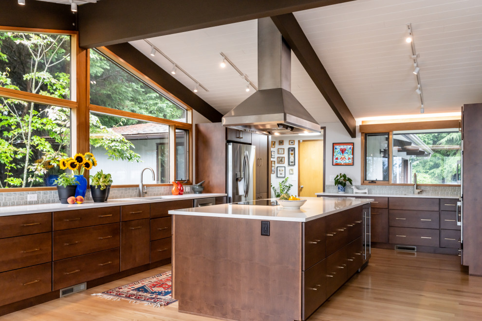 Design ideas for a mid-sized midcentury open plan kitchen in Other with an undermount sink, flat-panel cabinets, brown cabinets, quartz benchtops, green splashback, mosaic tile splashback, stainless steel appliances, light hardwood floors, with island, beige floor, white benchtop and exposed beam.