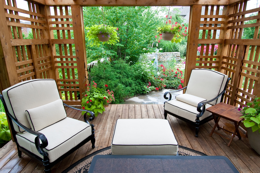 This is an example of a traditional backyard patio in Toronto with a gazebo/cabana.