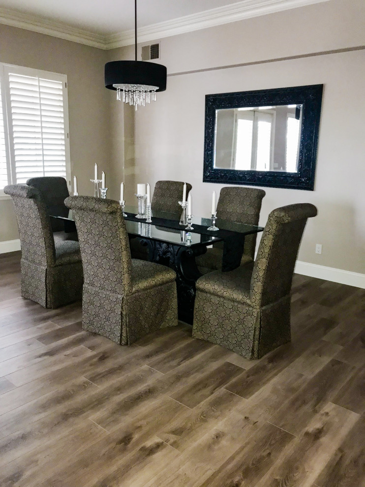 Mid-sized traditional separate dining room in Orange County with grey walls, vinyl floors and brown floor.