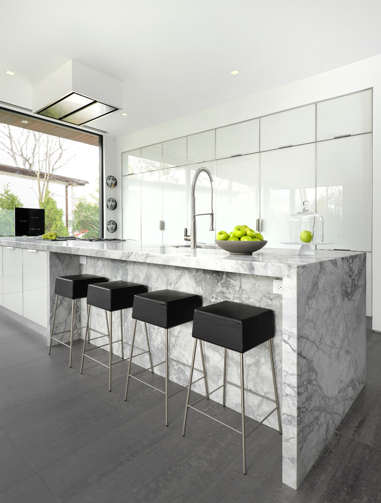 Design ideas for a contemporary galley eat-in kitchen in Chicago with white cabinets, quartzite benchtops, porcelain floors, with island and grey floor.