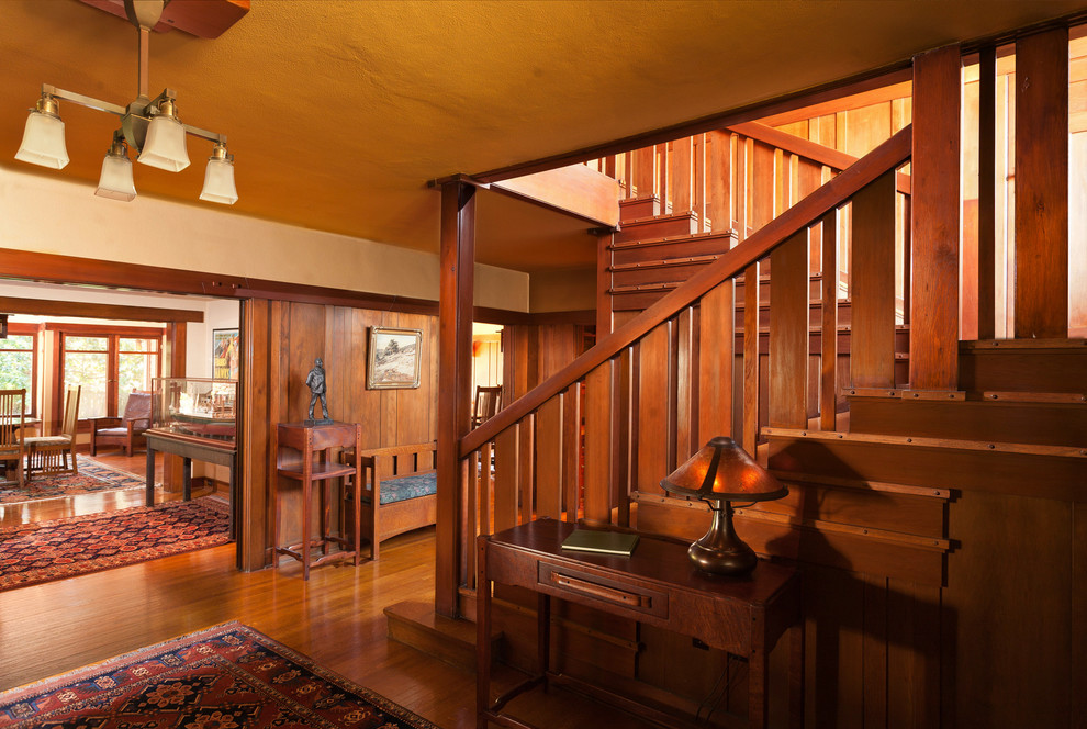 Inspiration for a large craftsman medium tone wood floor entryway remodel in Los Angeles with yellow walls and a medium wood front door