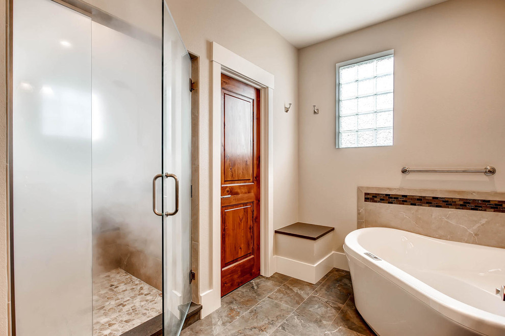 Corner bathtub - mid-sized transitional gray tile and porcelain tile porcelain tile corner bathtub idea in Denver with shaker cabinets, medium tone wood cabinets, a one-piece toilet, gray walls, an undermount sink and solid surface countertops