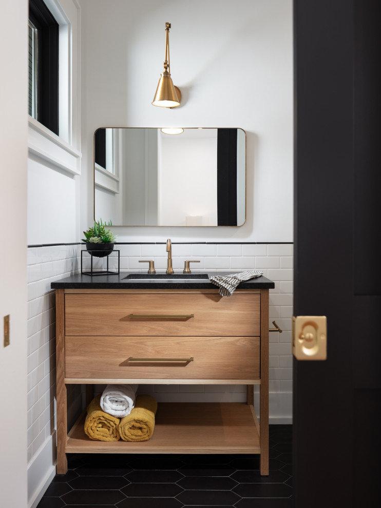 Country bathroom in Other with flat-panel cabinets, medium wood cabinets, white tile, subway tile, white walls, an undermount sink, black floor, black benchtops, a single vanity and a freestanding vanity.
