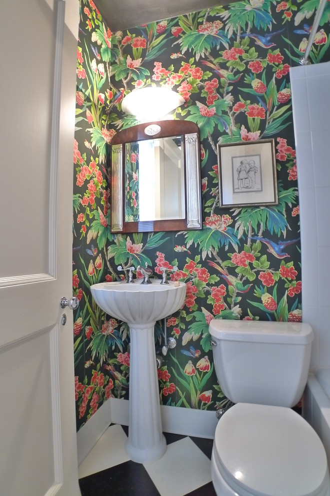 Photo of a small traditional 3/4 bathroom in Other with an alcove tub, a shower/bathtub combo, a two-piece toilet, multi-coloured walls, linoleum floors, a pedestal sink, multi-coloured floor and a shower curtain.
