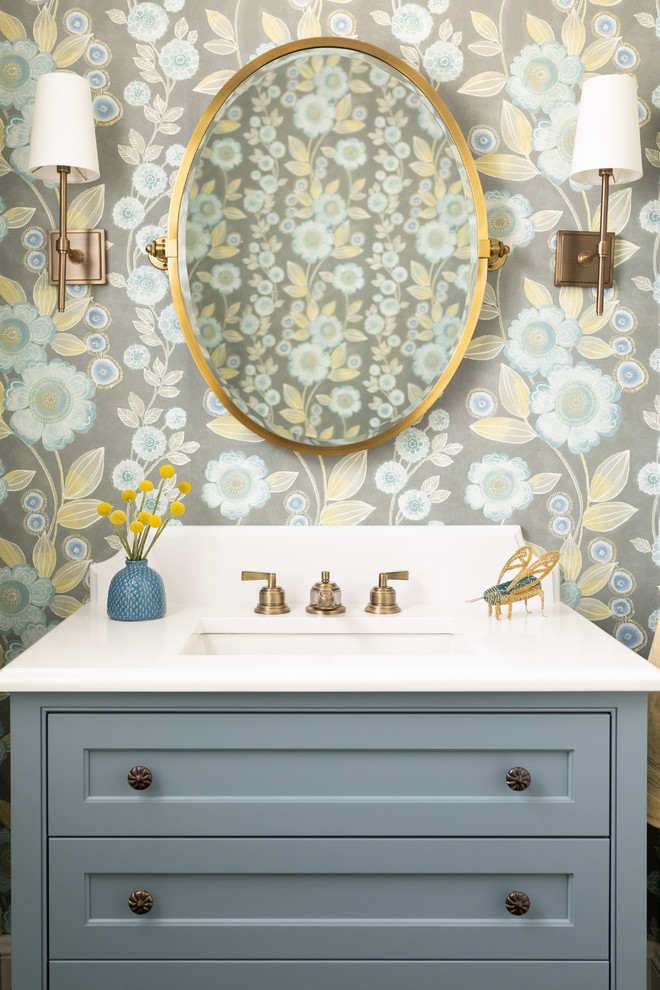 Design ideas for a beach style powder room in Boston with beaded inset cabinets, blue cabinets, multi-coloured walls, an undermount sink and white benchtops.