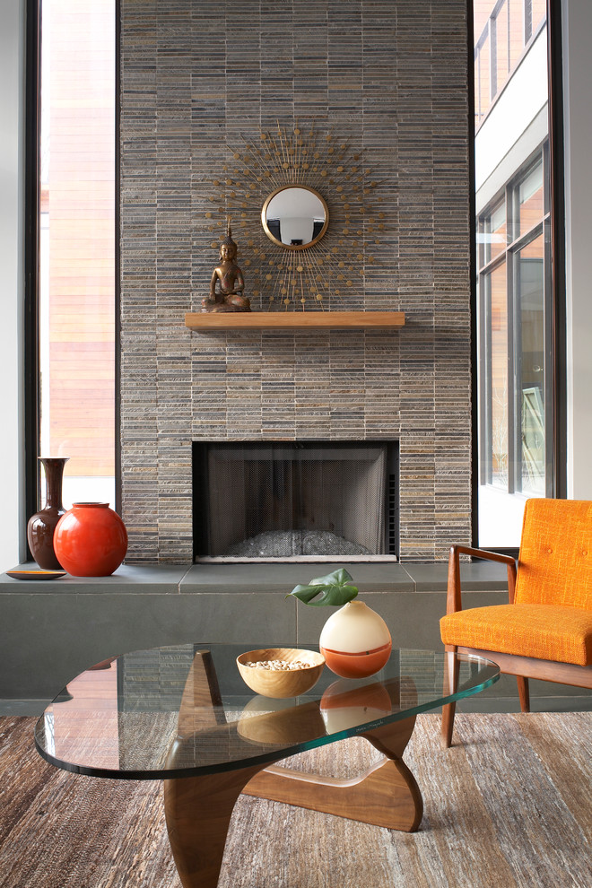 Modern loft-style living room in New York with a standard fireplace and a stone fireplace surround.