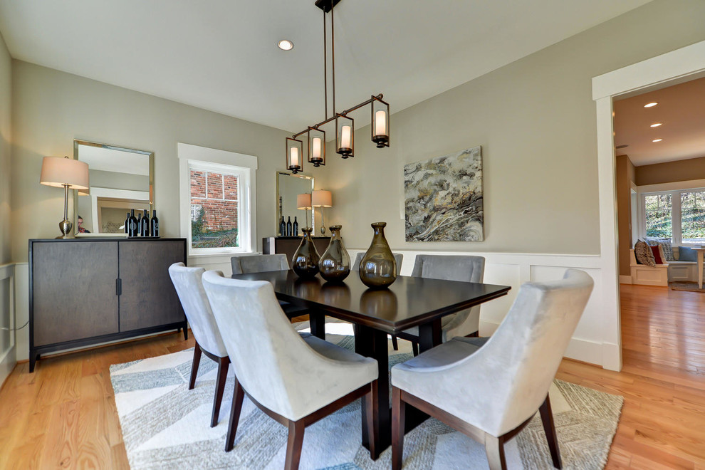 Photo of a transitional dining room in DC Metro with grey walls and light hardwood floors.