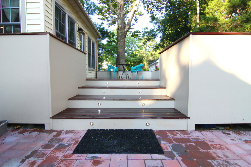 Mid-sized transitional backyard deck container garden photo with no cover