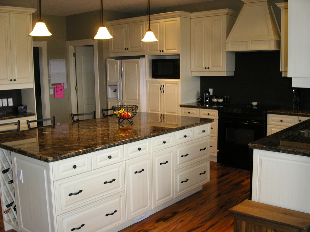 Mountain style kitchen photo in Calgary with raised-panel cabinets and distressed cabinets