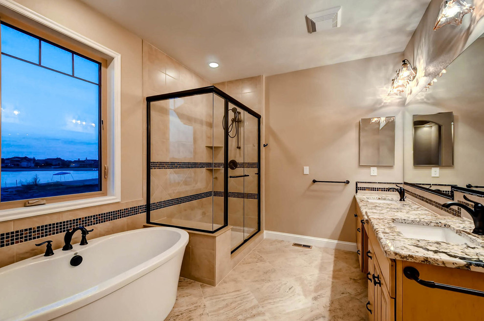 Inspiration for a mid-sized arts and crafts master bathroom in Denver with raised-panel cabinets, light wood cabinets, a freestanding tub, a corner shower, beige tile, ceramic tile, beige walls, ceramic floors, an undermount sink and granite benchtops.