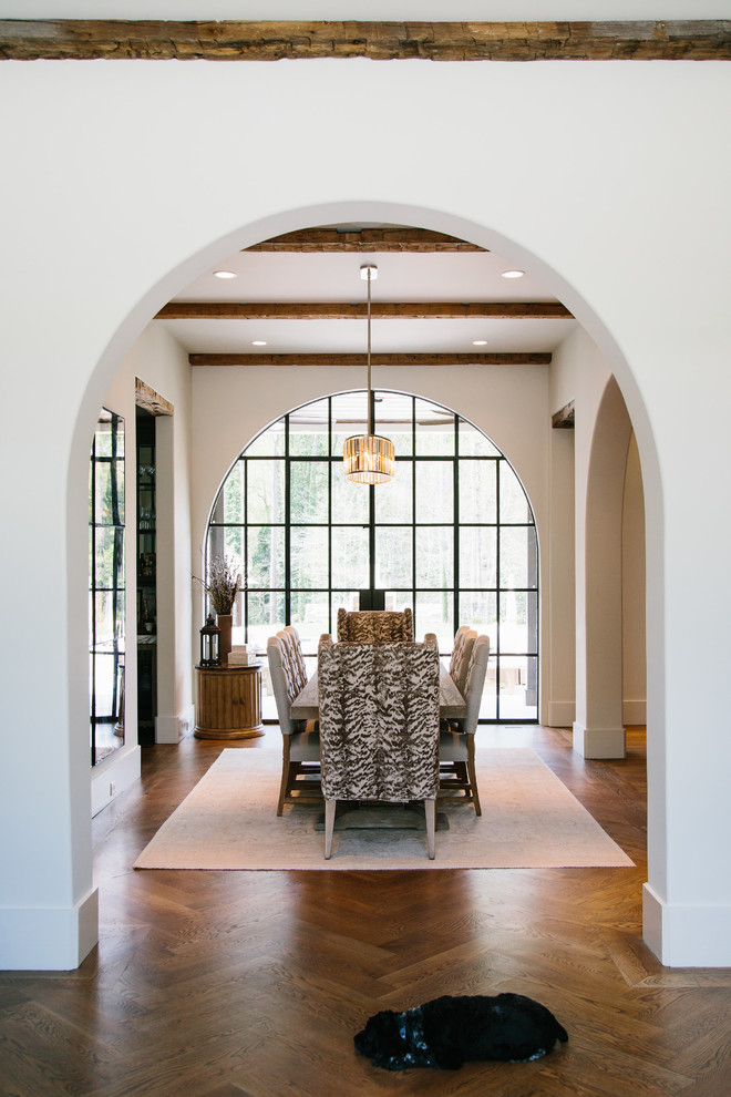 Photo of a mid-sized transitional separate dining room in Atlanta with white walls and medium hardwood floors.
