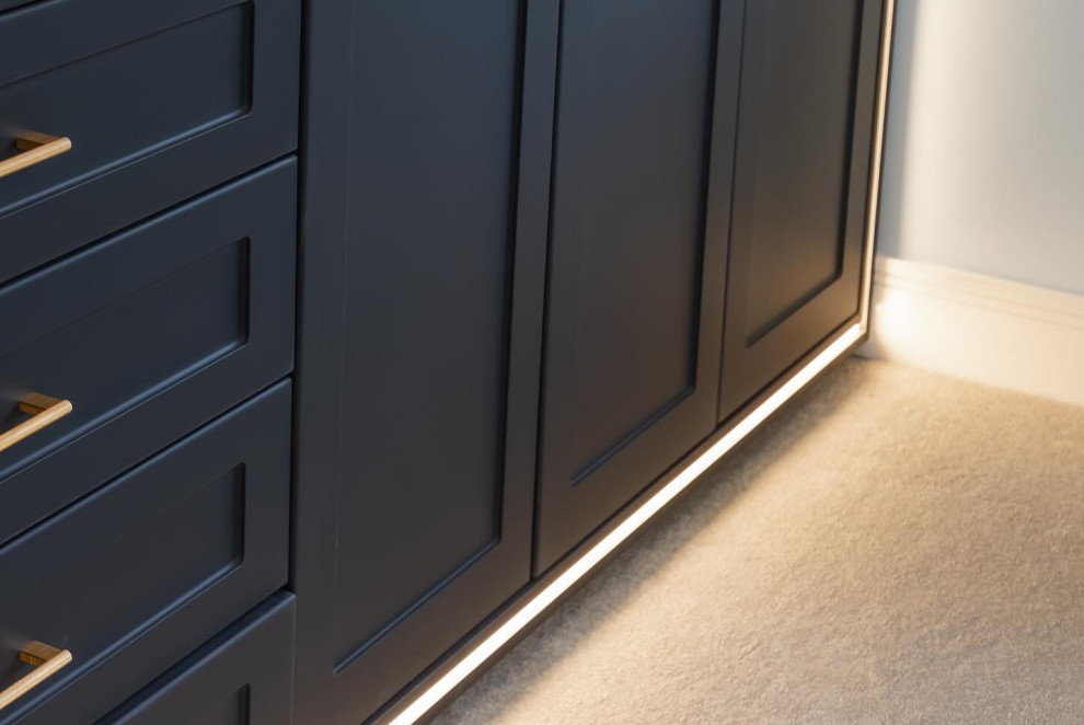 Photo of a medium sized contemporary gender neutral built-in wardrobe in Buckinghamshire with shaker cabinets, carpet and beige floors.
