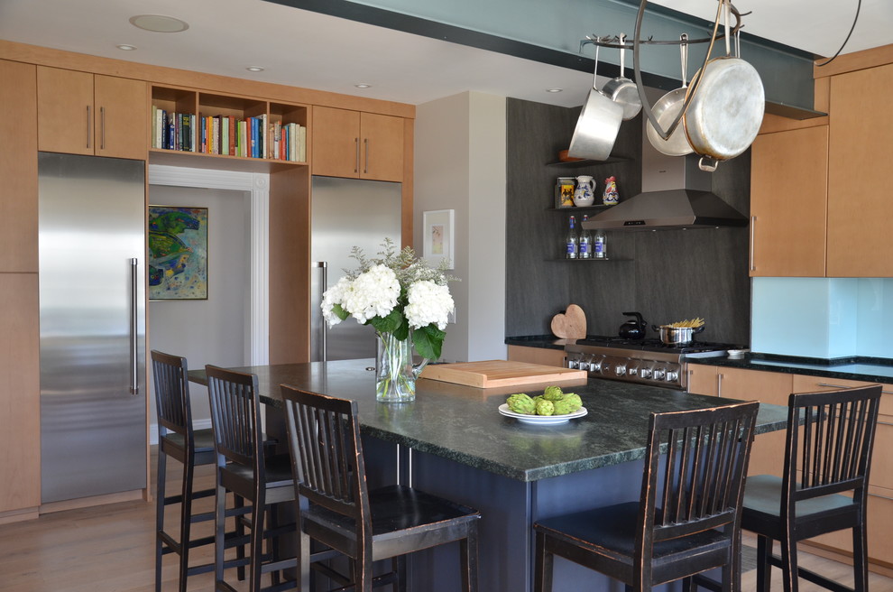 Example of a trendy kitchen design in Boston with flat-panel cabinets and an island