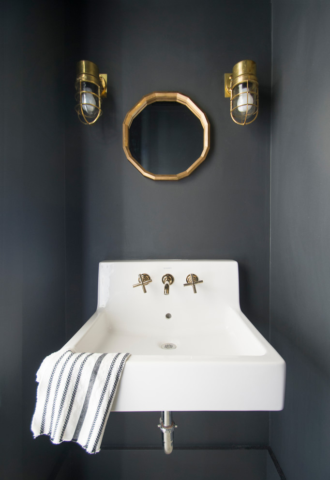 Inspiration for an industrial powder room in San Francisco with black walls and a wall-mount sink.