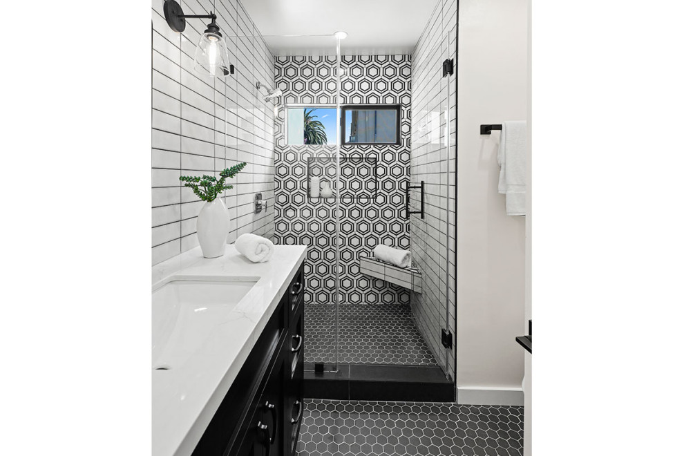 Photo of a medium sized classic shower room bathroom in Los Angeles with black cabinets, a single sink, recessed-panel cabinets, an alcove shower, white tiles, porcelain tiles, white walls, porcelain flooring, a submerged sink, engineered stone worktops, grey floors, a hinged door, white worktops, a wall niche, a shower bench and a built in vanity unit.