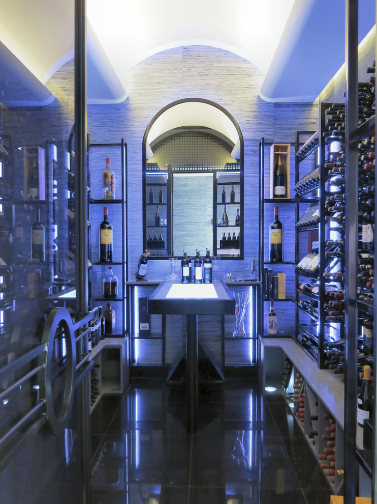 Photo of a large modern wine cellar in Madrid with display racks, black floor and porcelain floors.