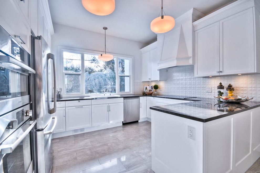 Mid-sized transitional u-shaped porcelain tile enclosed kitchen photo in Ottawa with a drop-in sink, shaker cabinets, white cabinets, marble countertops, white backsplash, porcelain backsplash, stainless steel appliances and no island