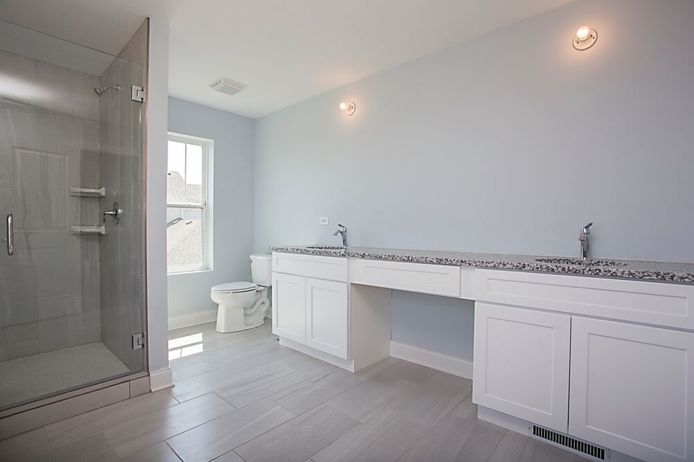 Drop-in bathtub - mid-sized transitional master gray tile and porcelain tile porcelain tile and beige floor drop-in bathtub idea in Chicago with recessed-panel cabinets, white cabinets, blue walls, an undermount sink, quartz countertops and a hinged shower door