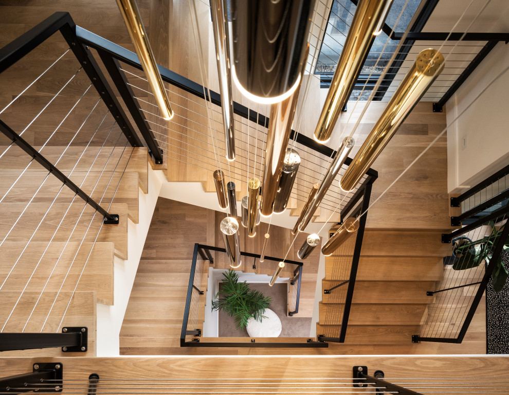 Inspiration for a large contemporary wood l-shaped staircase in Minneapolis with wood risers and metal railing.