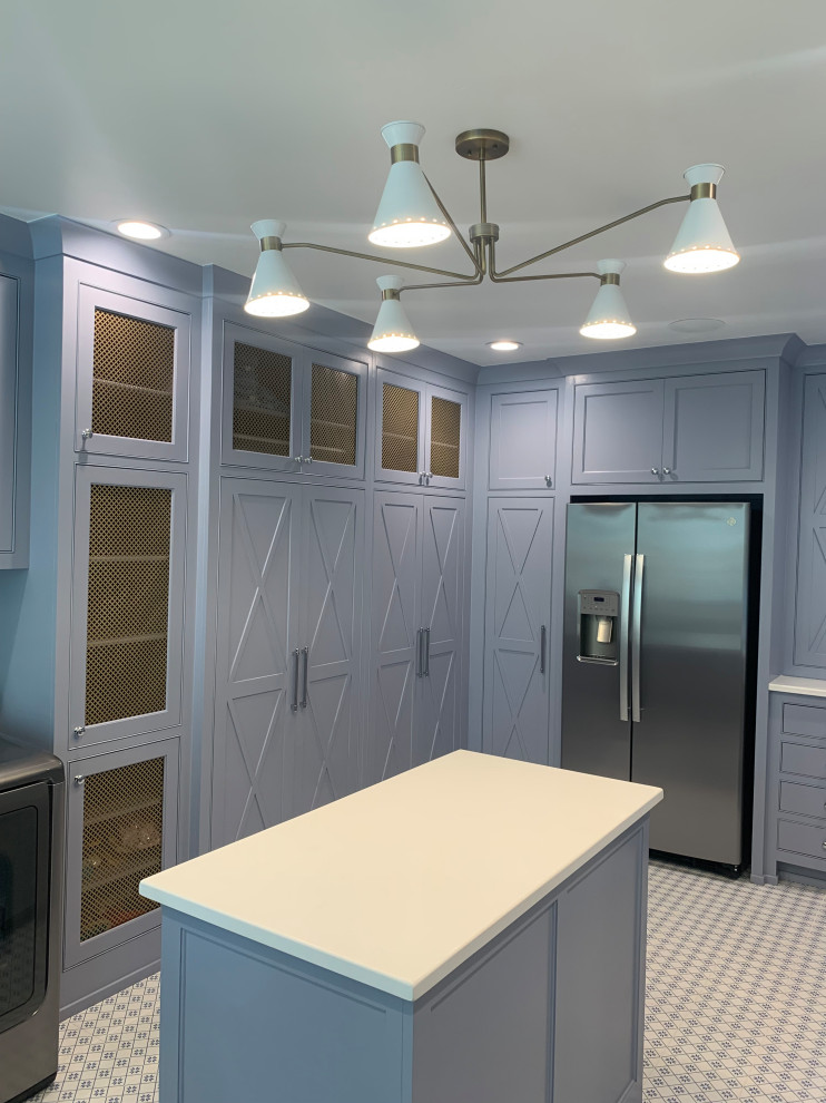 Inspiration for a traditional u-shaped utility room in Oklahoma City with blue cabinets, quartz benchtops, porcelain floors, a side-by-side washer and dryer, white benchtop and wallpaper.