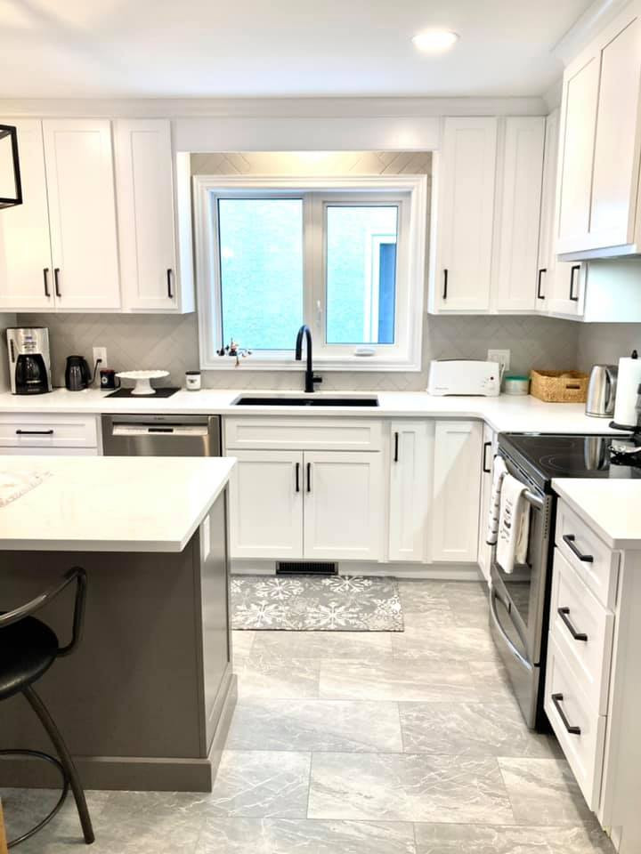 Enclosed kitchen - mid-sized transitional galley ceramic tile and gray floor enclosed kitchen idea with a double-bowl sink, shaker cabinets, white cabinets, quartz countertops, gray backsplash, ceramic backsplash, stainless steel appliances, an island and white countertops