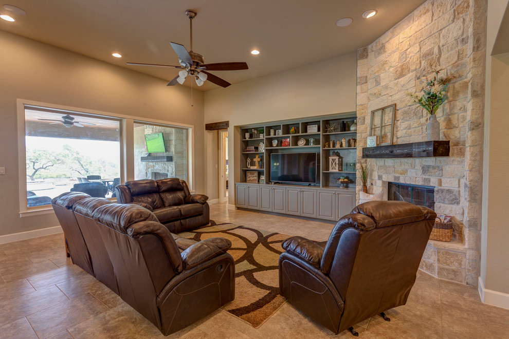 Design ideas for a large country open concept family room in Austin with beige walls, ceramic floors, a corner fireplace, a stone fireplace surround, a built-in media wall and beige floor.