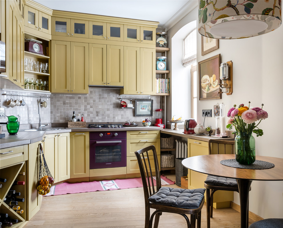 Inspiration for a contemporary single-wall kitchen in Moscow with a drop-in sink, shaker cabinets, yellow cabinets, grey splashback, coloured appliances, no island, beige floor and grey benchtop.