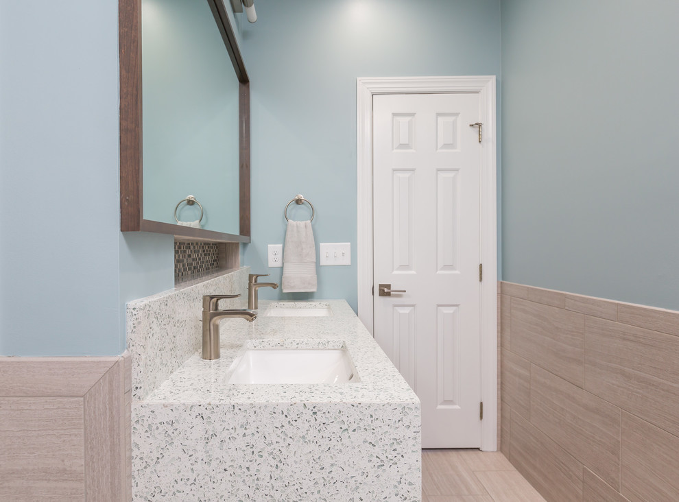 This is an example of a contemporary master bathroom in Raleigh with shaker cabinets, medium wood cabinets, a freestanding tub, a curbless shower, a two-piece toilet, gray tile, porcelain tile, blue walls, porcelain floors, an undermount sink and engineered quartz benchtops.