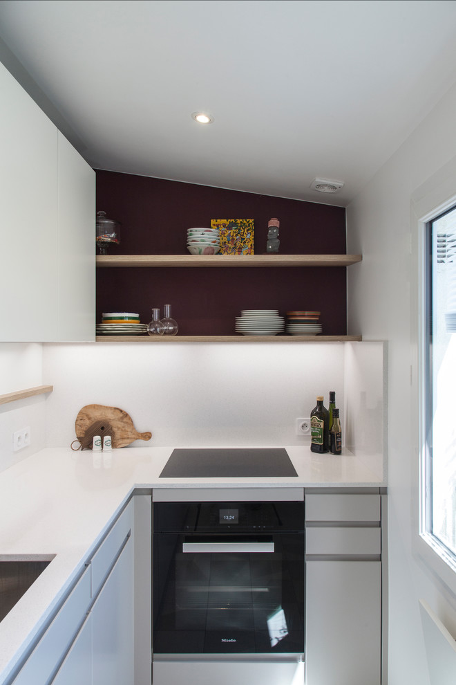 Mid-sized contemporary l-shaped separate kitchen in Paris with an undermount sink, flat-panel cabinets, grey cabinets, quartzite benchtops, white splashback, engineered quartz splashback, panelled appliances, ceramic floors, no island, white floor and white benchtop.