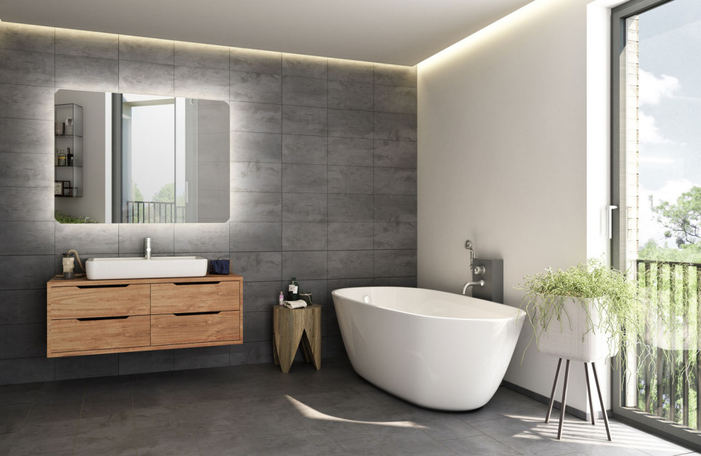 Inspiration for a large contemporary master bathroom in Other with light wood cabinets, gray tile, ceramic tile, multi-coloured walls, cement tiles, wood benchtops, grey floor, brown benchtops, a single vanity, a floating vanity, recessed-panel cabinets, a freestanding tub and a vessel sink.